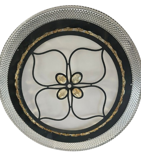 A white finish LED ceiling lamp with a geometric pattern and a central decorative element, surrounded by a silver-colored rim.